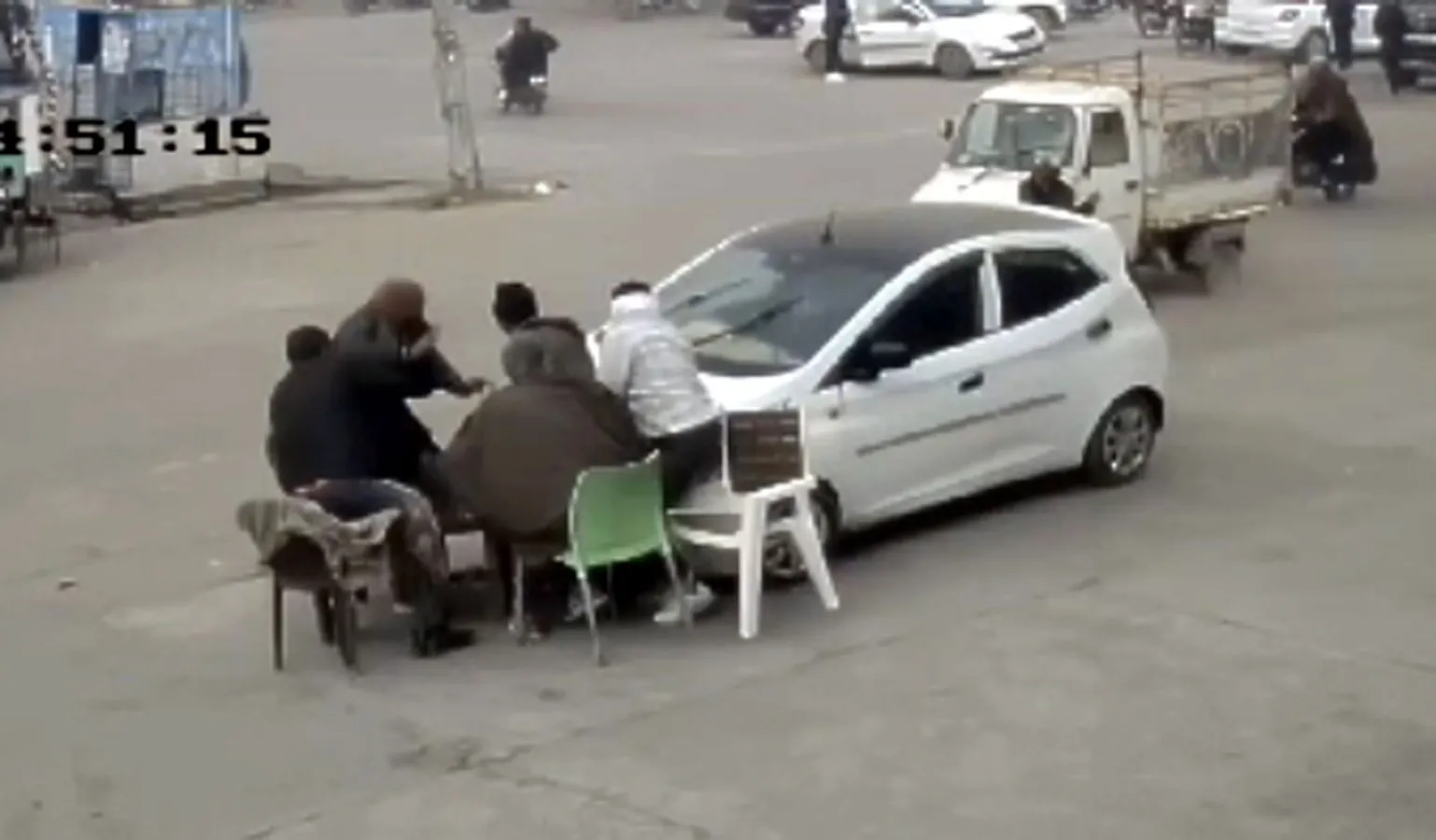The young man who was learning to drive drove over the people sitting near the shop